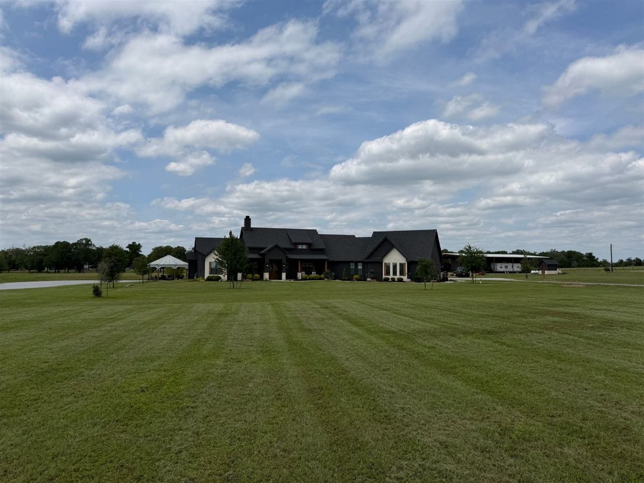 Freshly striped lawn in front of a custom country home